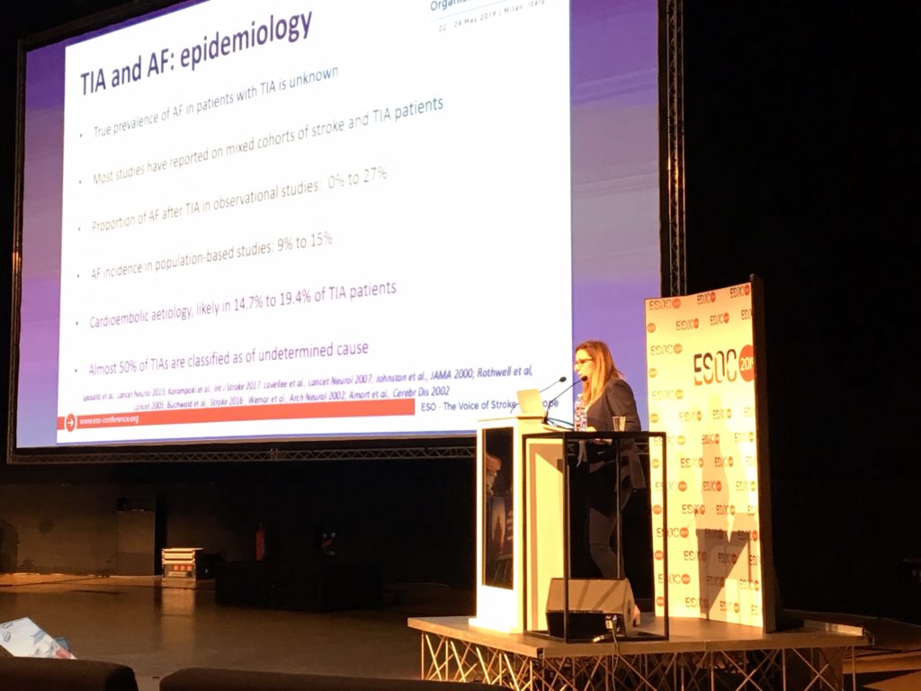 Dr Eleni Korompoki standing at a podium presenting at ESOC2019